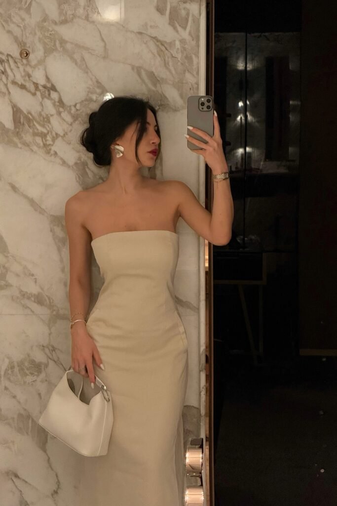 Cream Strapless Column Dress + Statement Silver Earrings + White Top-Handle Bag