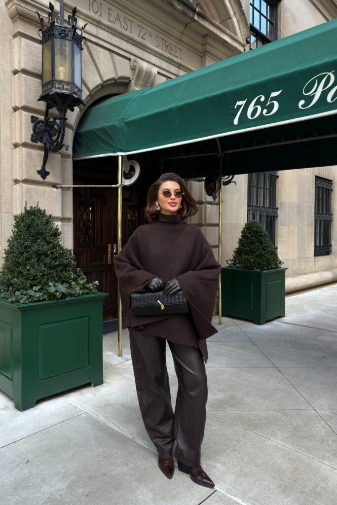 Dark Brown High-Neck Poncho + Brown Leather Trousers + Dark Brown Boots + Black Woven Clutch