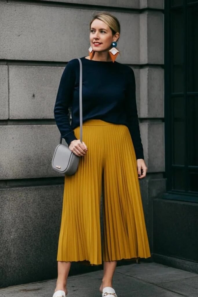 Navy Blue Crewneck Sweater + Mustard Yellow Pleated Culottes + White Horsebit Mules + Grey Crossbody Bag