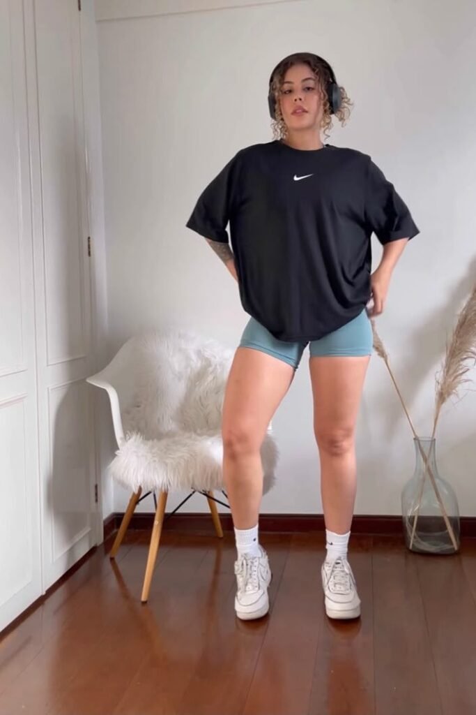 Oversized Black Nike T-Shirt + Teal Biker Shorts + White Crew Socks + White Sneakers