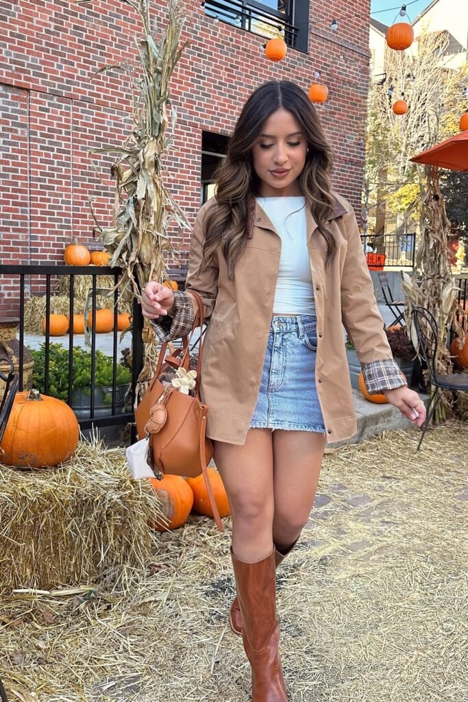 Tan Trench/Mac Jacket + Light Blue Crop Top + Light Wash Denim Mini Skirt + Brown Knee-High Boots