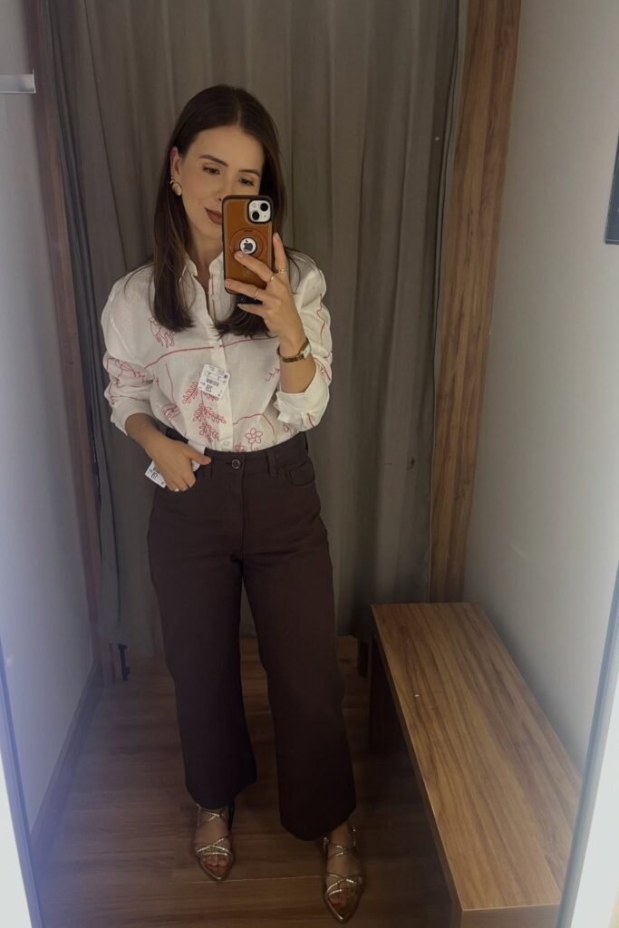 White Button-Down Shirt with Red Floral Embroidery + Dark Brown Trousers + Gold Strappy Sandals