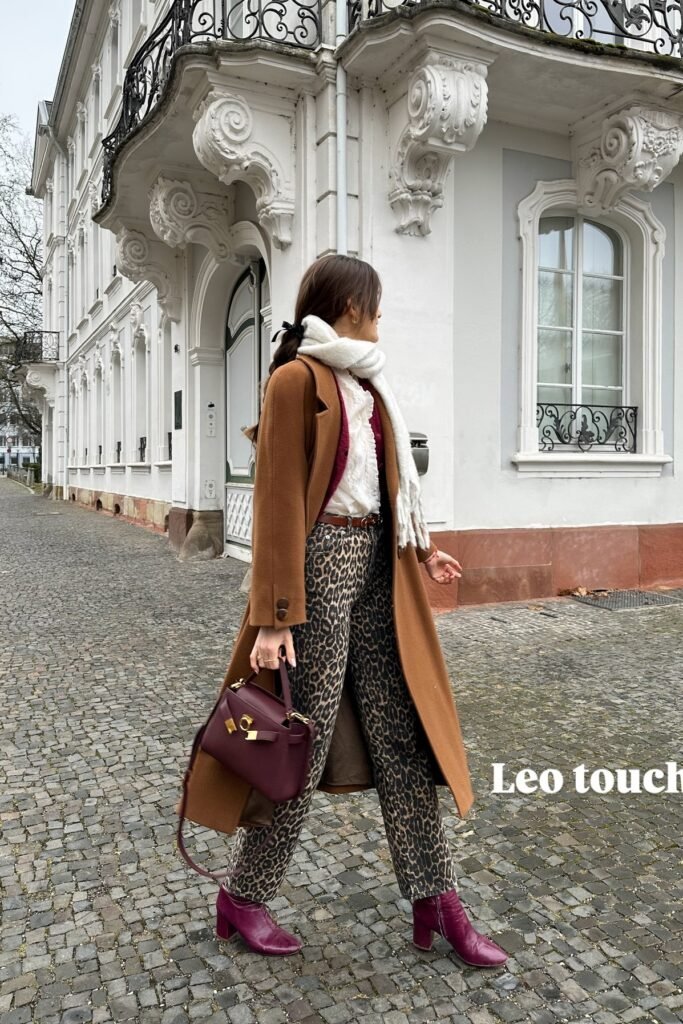 White Ruffle Blouse + Leopard Print Straight-Leg Jeans + Camel Long Coat + Burgundy Ankle Boots