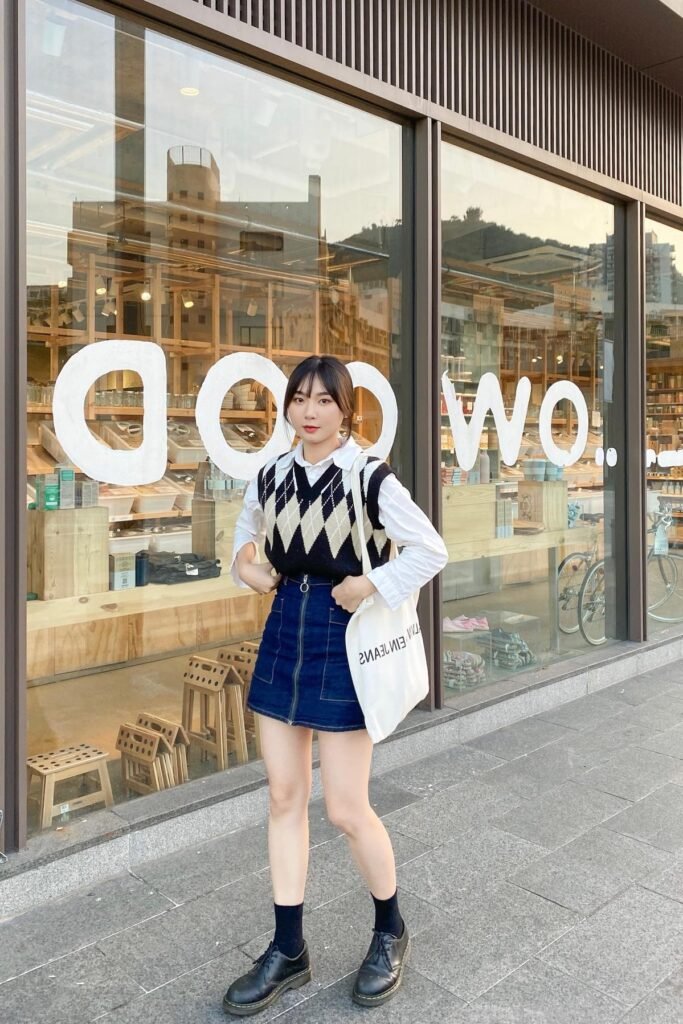 Argyle Knit Vest + White Long-Sleeve Button-Up Shirt + Denim Mini Skirt + Black Dress Shoes with Black Socks