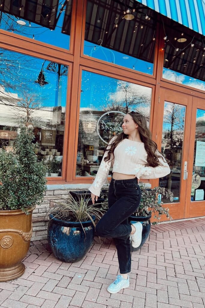 Beige Floral Crop Sweater + Black Straight-Leg Jeans + White and Light Blue Sneakers