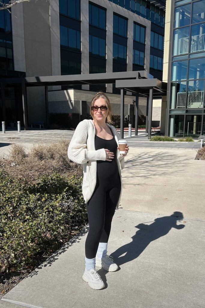 Black Bodycon Jumpsuit + Cream Oversized Cardigan + White Sneakers with Tall White Socks