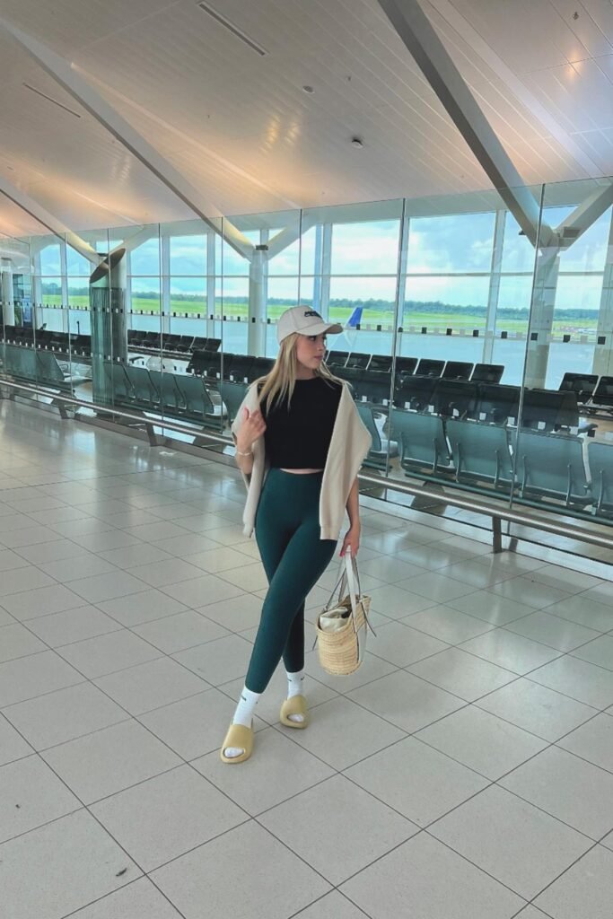 Black Crop Top + Dark Green Leggings + Beige Sweater (Draped) + Beige Baseball Cap + Yellow Slides