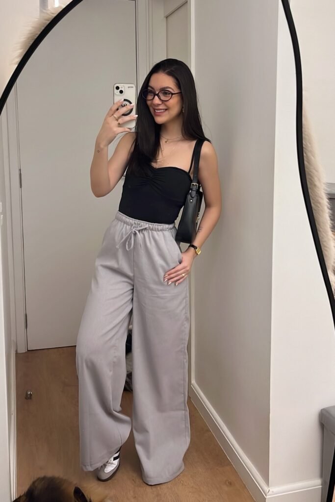 Black Gathered Bodysuit + Grey Wide-Leg Drawstring Trousers + Grey and White Sneakers + Black Shoulder Bag