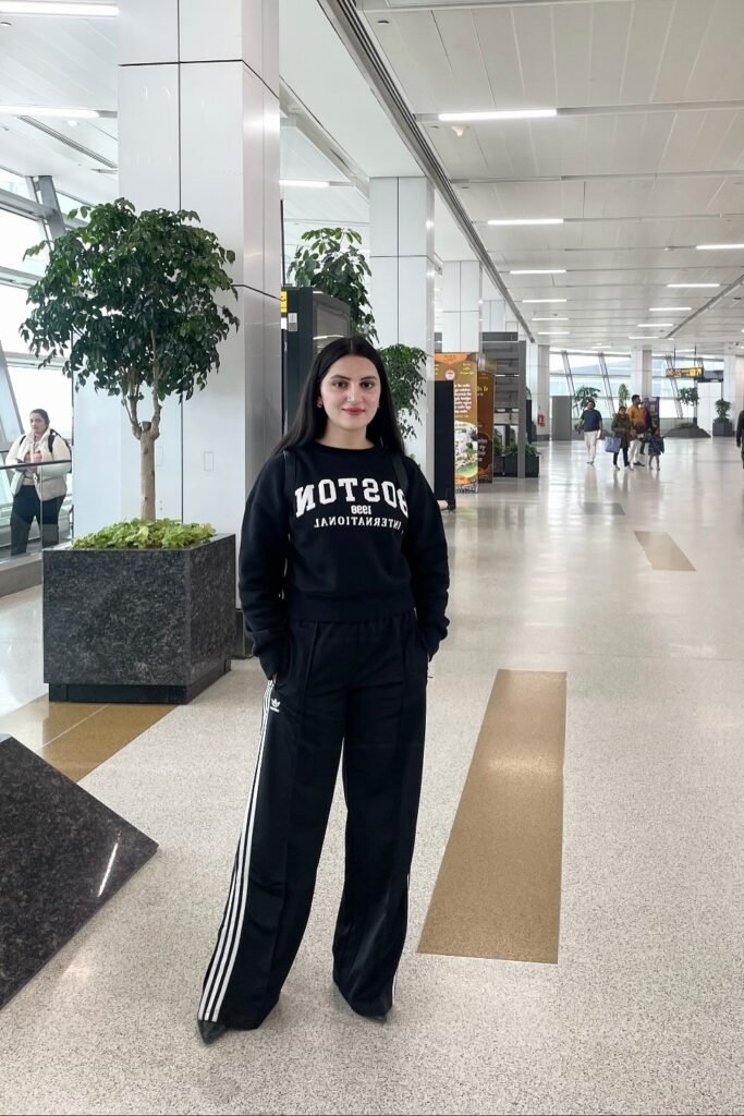Black Graphic Sweatshirt + Black Adidas Track Pants + Black Pointed-Toe Boots