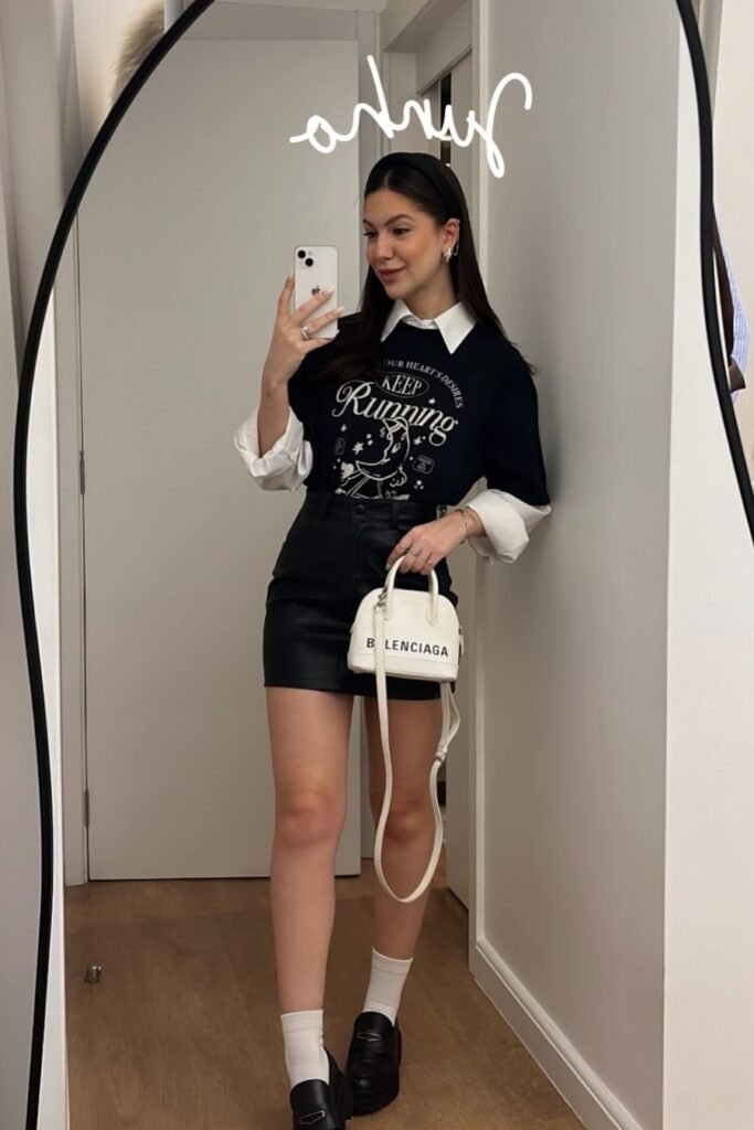 Black Graphic T-Shirt over White Collared Shirt + Black Leather Mini Skirt + White Socks and Black Loafers