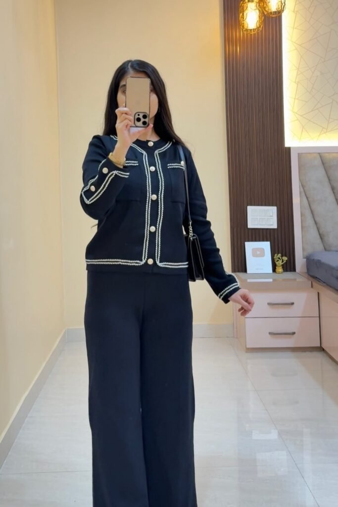 Black Knit Cardigan with White Trim + Matching Black Wide-Leg Trousers + Gold Bracelet + Black Shoulder Bag