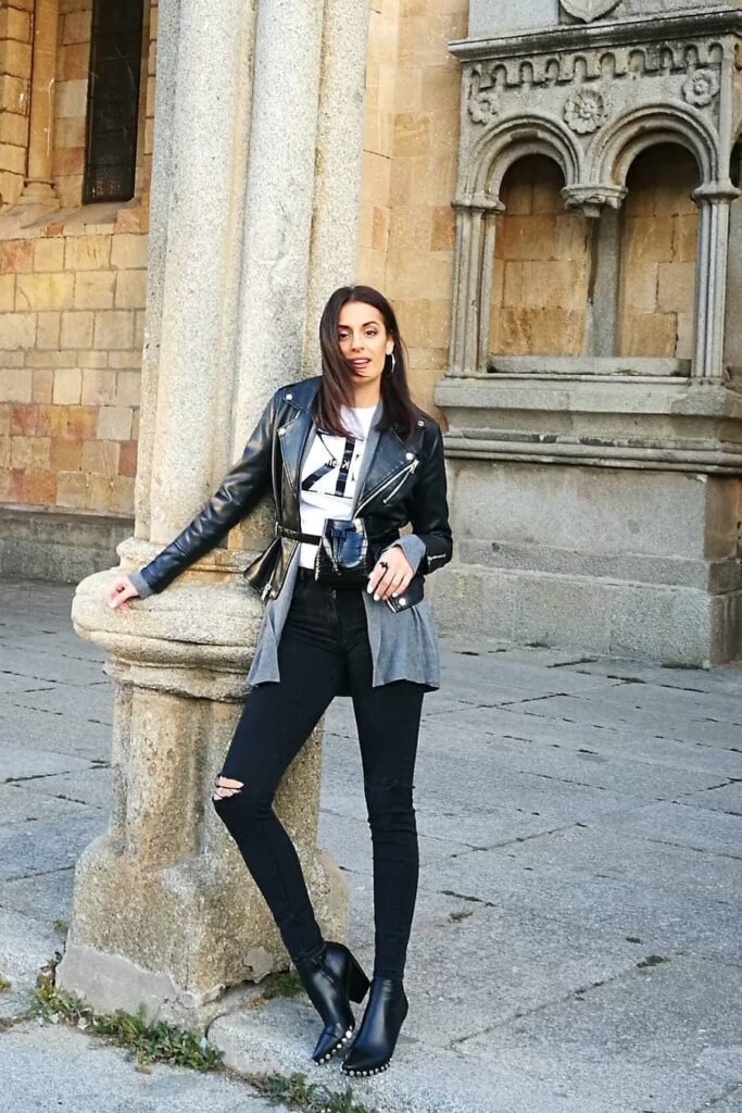 Black Leather Biker Jacket + White Logo T-Shirt + Grey Cardigan + Black Distressed Skinny Jeans + Black Pointed Toe Boots