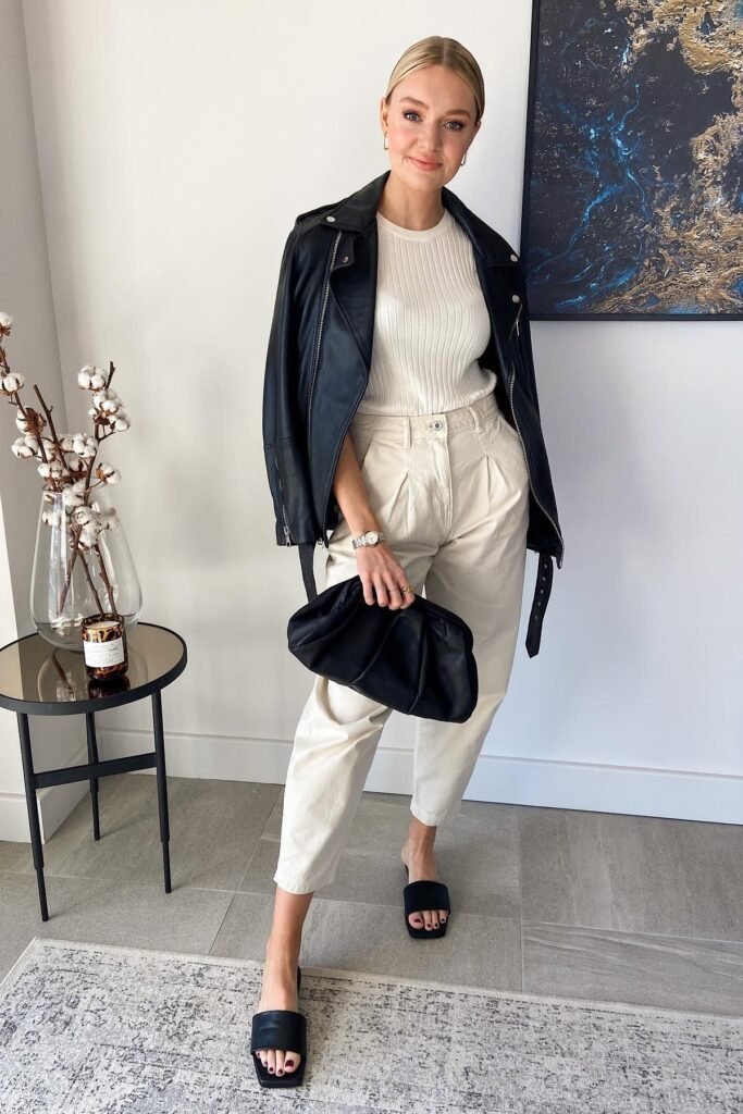 Black Leather Biker Jacket + White Ribbed Top + Cream Pleated Trousers + Black Square-Toe Slides