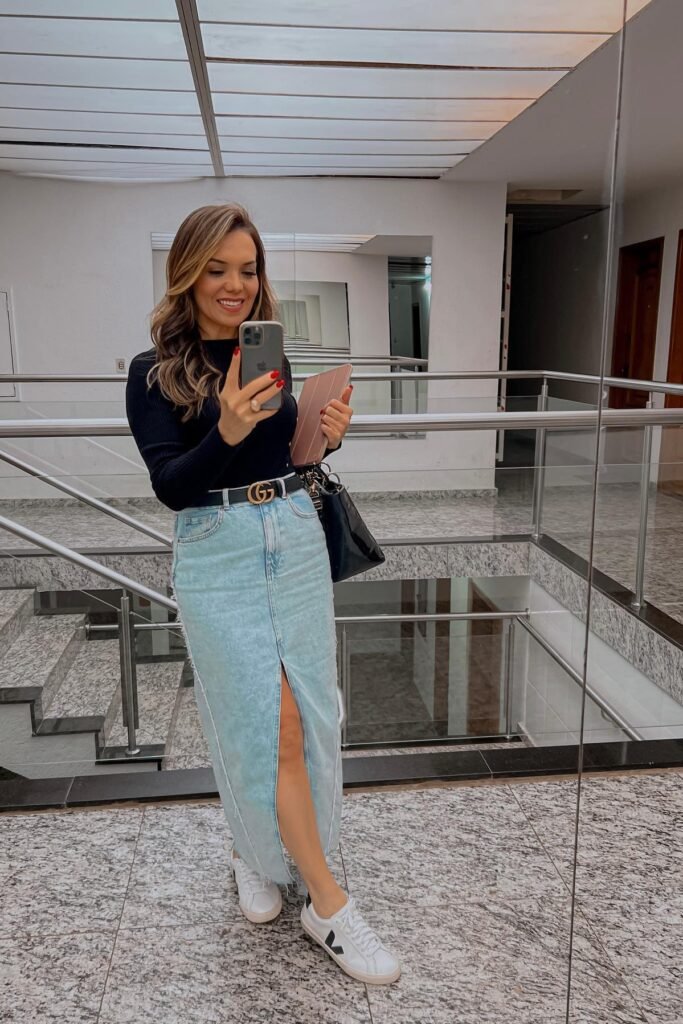 Black Long-Sleeve Ribbed Top + Light Wash Denim Maxi Skirt with Slit + Black Logo Belt + White Veja Sneakers