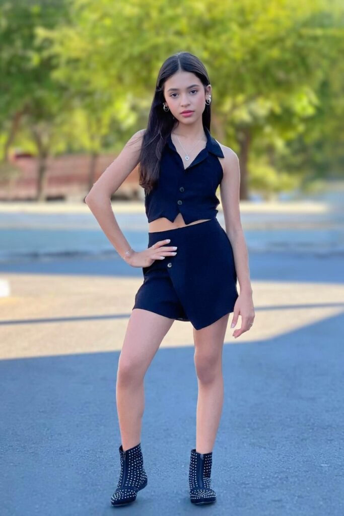 Black Sleeveless Button-Up Vest + Matching Black Mini Skort + Black Studded Boots