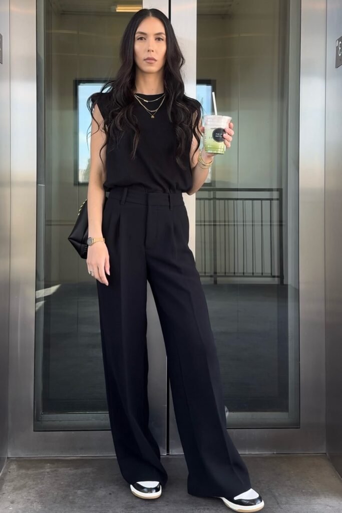 Black Sleeveless Top + Black High-Waisted Trousers + Black and White Sneakers
