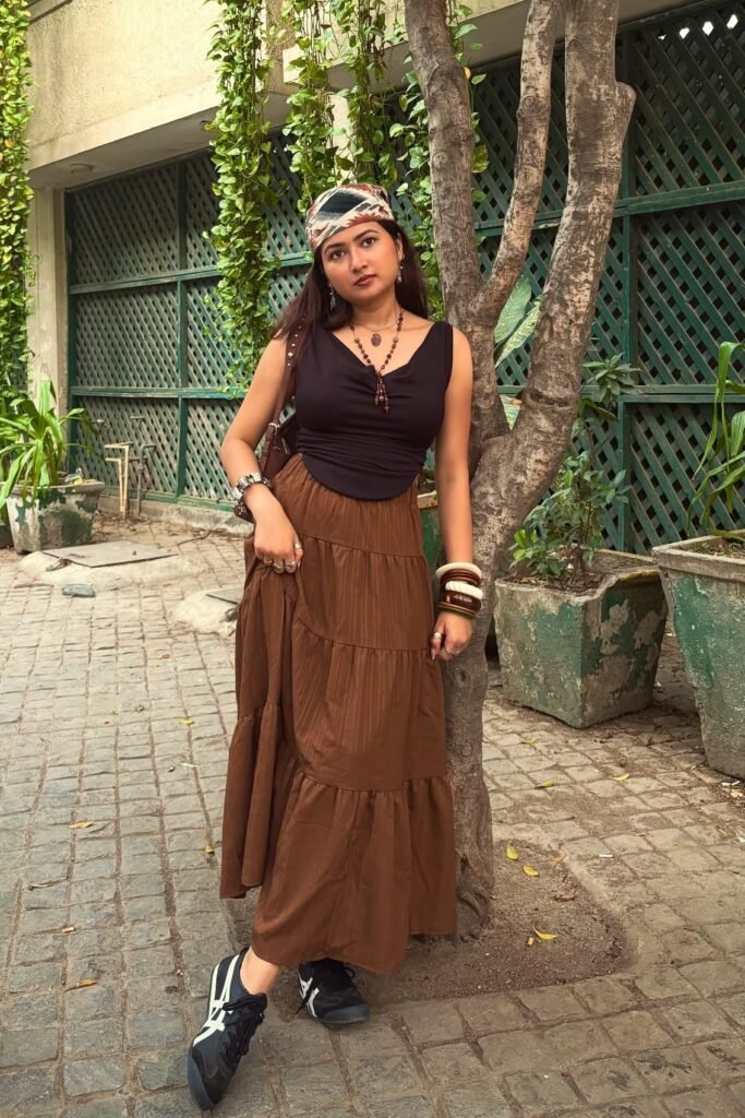 Black V-Neck Corset Top + Brown Tiered Maxi Skirt + Patterned Headscarf + Black and White Sneakers