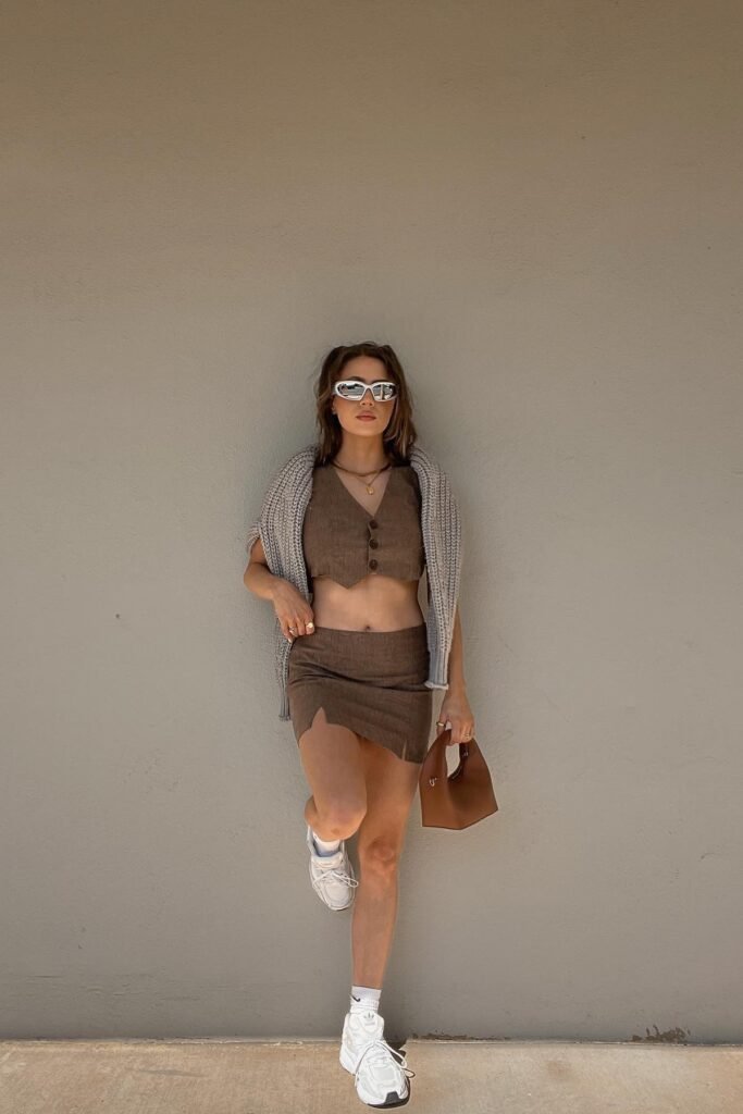 Brown Cropped Vest & Mini Skirt Set + Grey Cable-Knit Sweater (shoulders) + White Athletic Sneakers