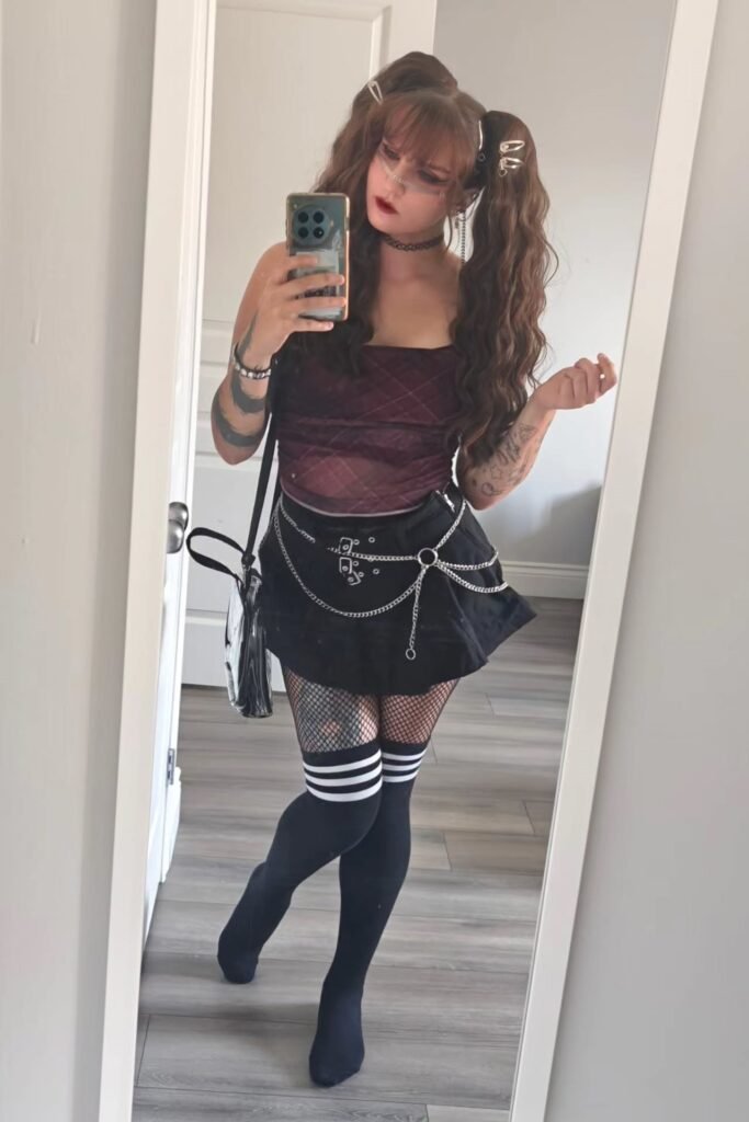 Burgundy Plaid Mesh Cami + Black Pleated Mini Skirt with Chain Belt + Fishnet Tights + Striped Over-the-Knee Socks