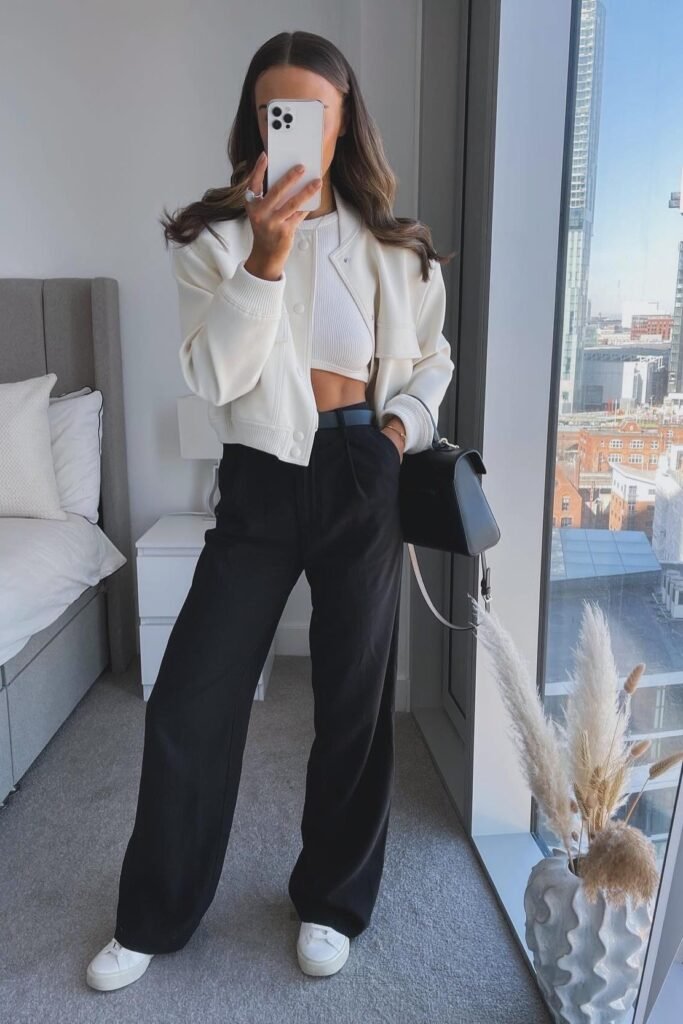 Cream Cropped Bomber Jacket + White Ribbed Crop Top + Black Wide-Leg Trousers + White Sneakers