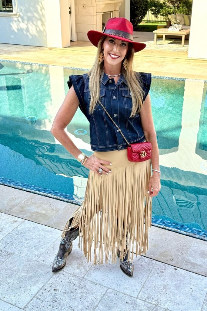 Dark Wash Denim Sleeveless Shirt + Tan Fringe Midi Skirt + Embroidered Brown Western Boots + Red Wide-Brim Hat