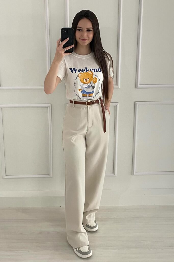 Graphic "Weekend" Teddy Bear T-Shirt + High-Waisted Beige Trousers + Brown Leather Belt + White Platform Sneakers