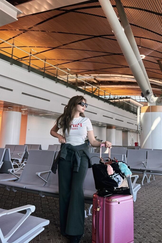 Graphic White T-Shirt + Dark Grey Flared Trousers + Black Sunglasses