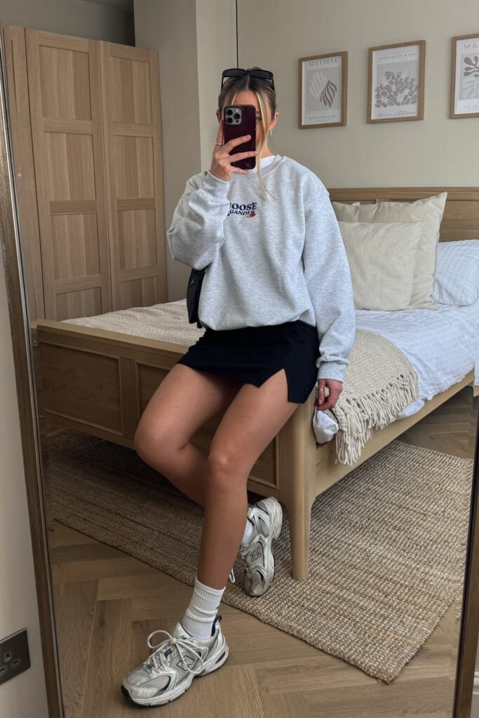 Grey Graphic Sweatshirt + Black Mini Skirt + Silver Sneakers
