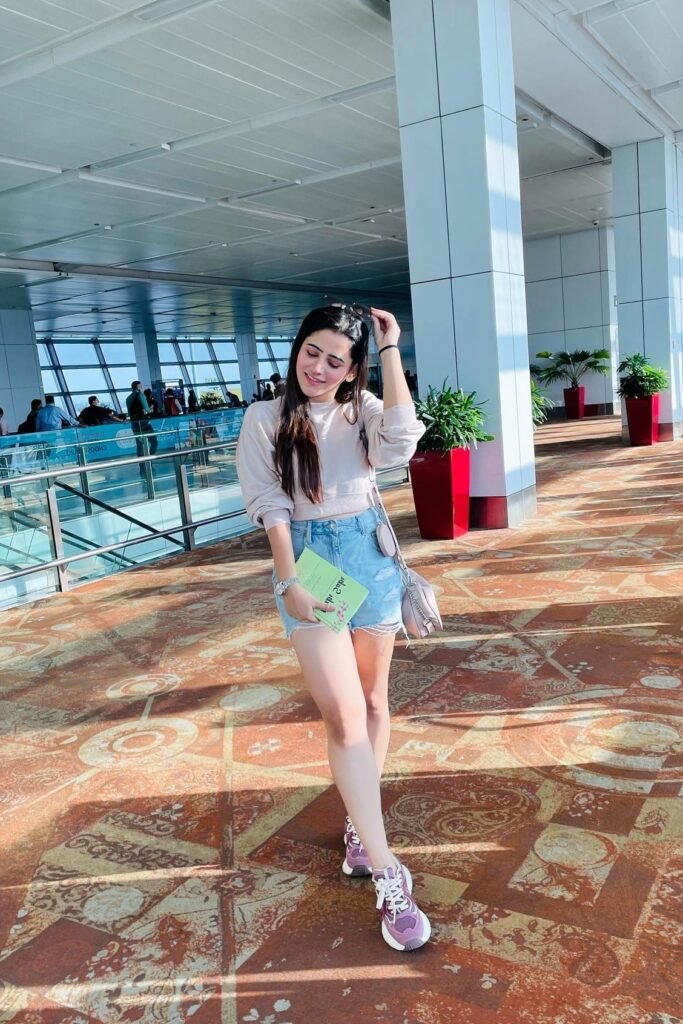 Light Beige Cropped Sweatshirt + Distressed Denim Shorts + Purple and White Sneakers