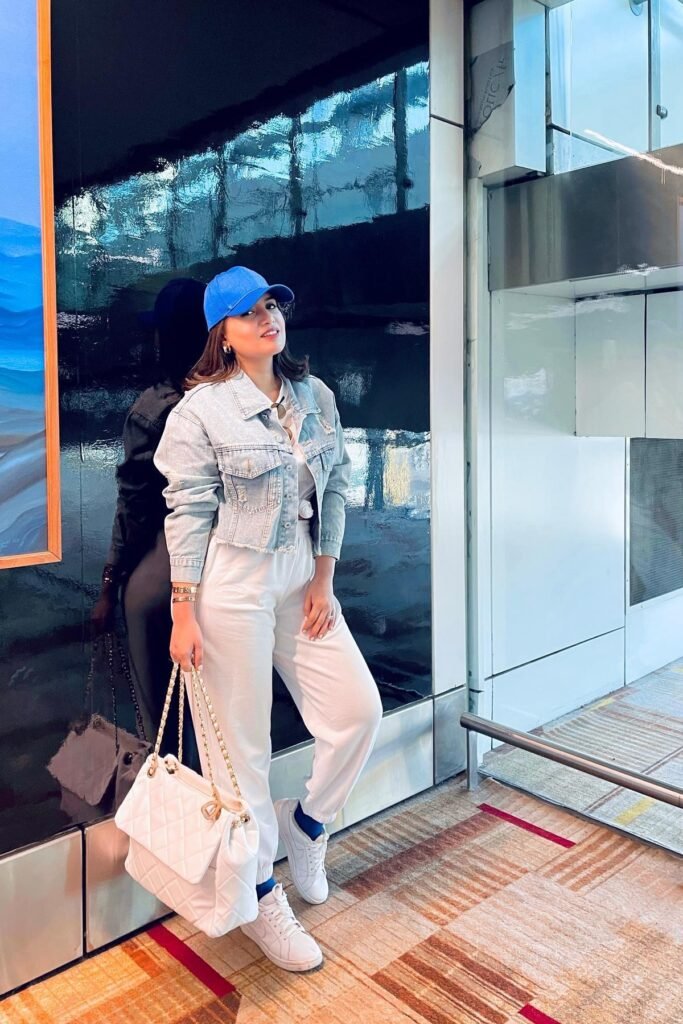 Light Wash Cropped Denim Jacket + White Crop Top + White Joggers + Blue Baseball Cap + White Sneakers