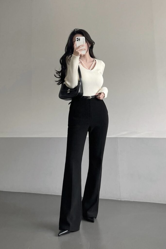 Off-White Ribbed V-Neck Sweaker + Black High-Waisted Flared Trousers + Black Shoulder Bag