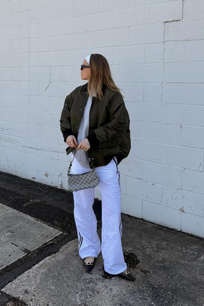 Olive Bomber Jacket + Grey Oversized Sweatshirt + White Track Pants + Black Pointed Flats
