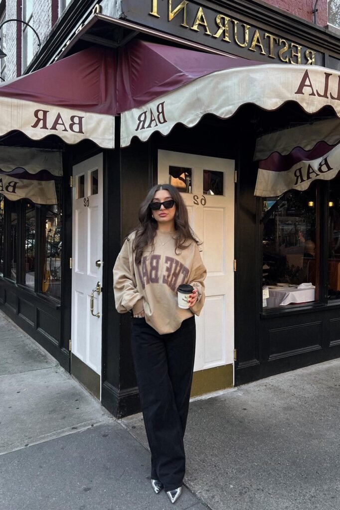 Oversized Tan Graphic Sweatshirt + Black Wide-Leg Trousers + Silver Pointed-Toe Heels