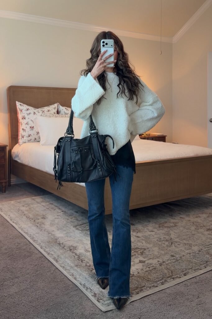 Oversized White Fuzzy Sweater + Black Lace Camisole + Blue Flared Jeans + Black Pointed-Toe Boots + Large Black Moto Bag