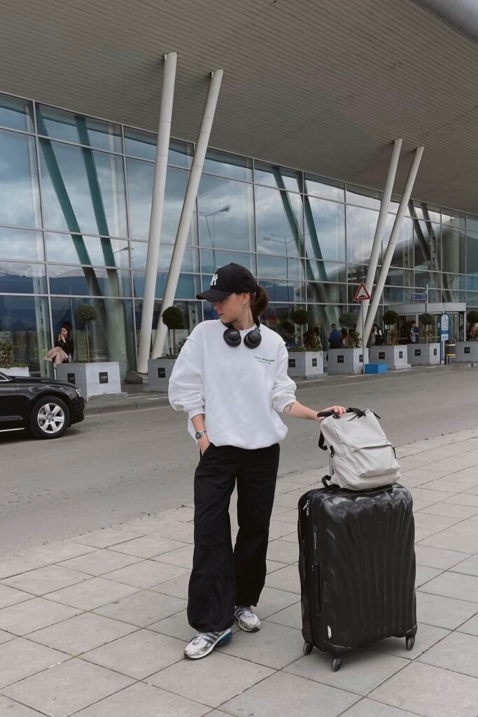 Oversized White Sweatshirt + Black Wide-Leg Cargo Pants + Silver Athletic Sneakers