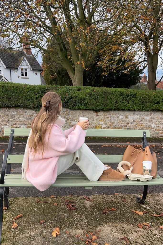Pale Pink Oversized Knit Sweater + White Wide-Leg Trousers + Chestnut Shearling Boots