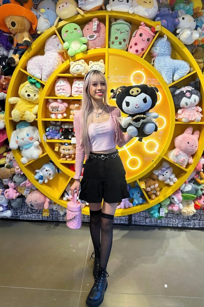 Pink Cardigan & Butterfly Crop Top + Black Tiered Mini Skirt + Black Lace-Up Boots