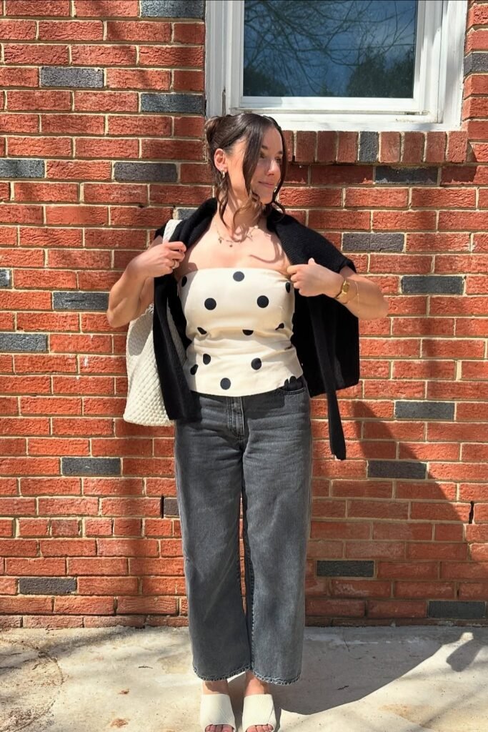 Polka Dot Strapless Top + Black Cardigan (over shoulders) + Charcoal Straight-Leg Jeans + White Mules
