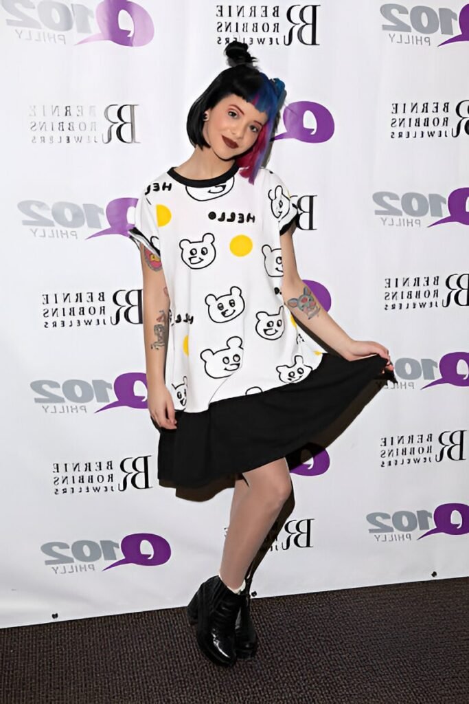 White Bear-Print Graphic Tee + Black Mini Skirt + Black Heeled Boots