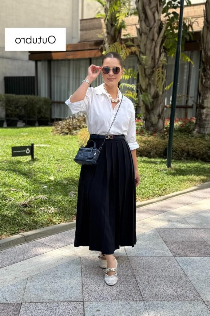 White Button-Down Shirt + Black Pleated Midi Skirt + Black Crossbody Bag + White Perforated Flats