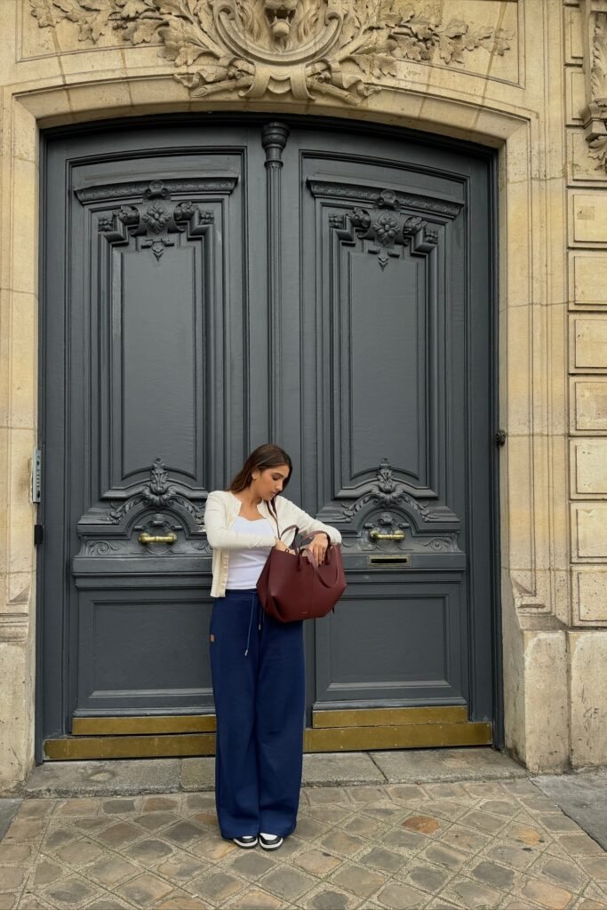 White Cardigan + White Tank Top + Navy Wide-Leg Trousers + Black & White Sneakers