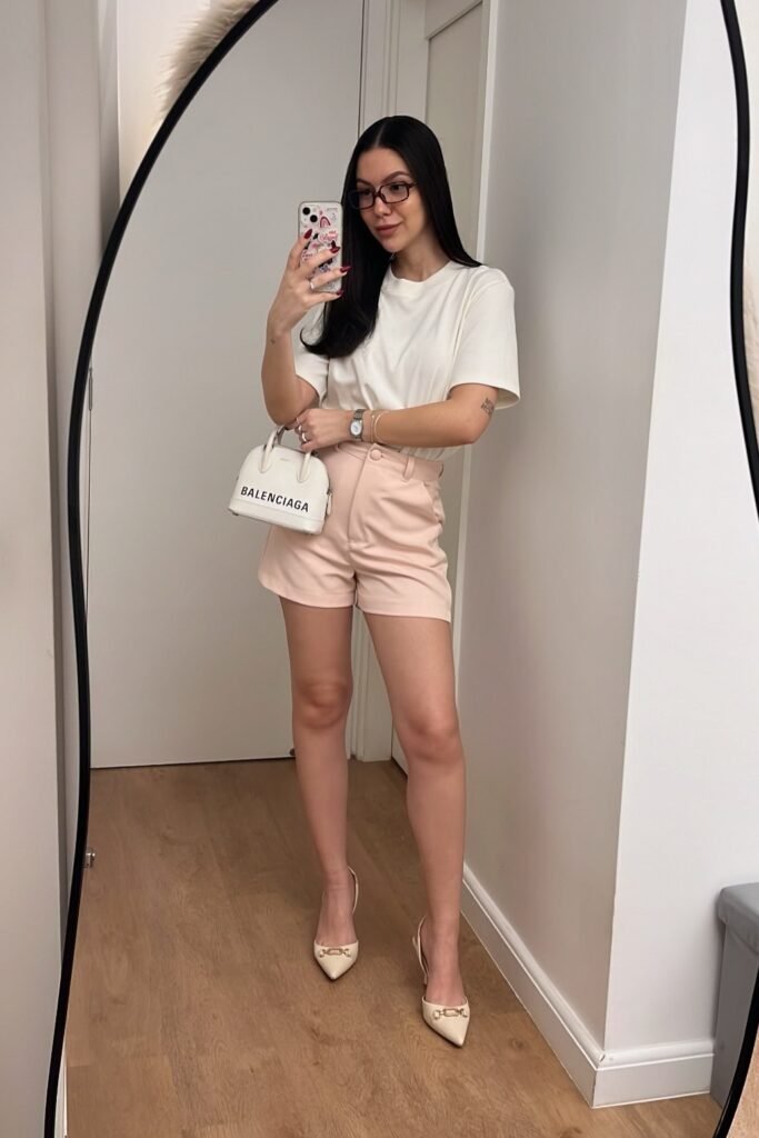 White Crewneck T-Shirt + Light Pink Tailored Shorts + Cream Pointed-Toe Heels + White Logo Handbag