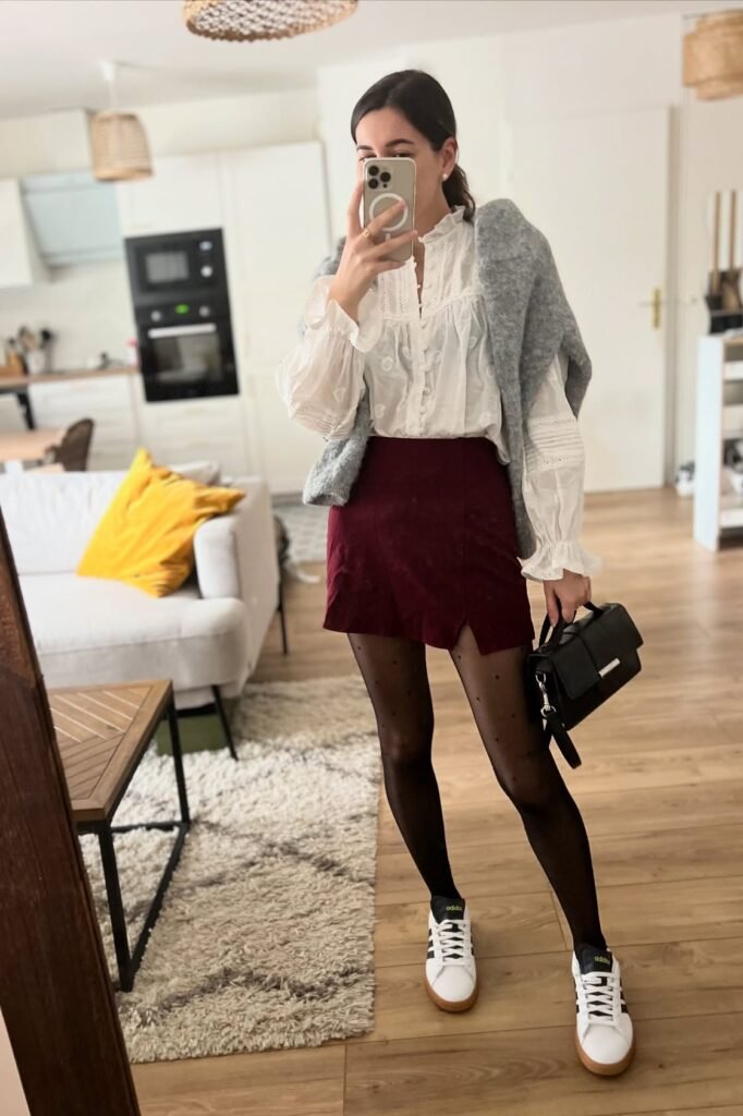 White Eyelet Ruffle Blouse + Grey Oversized Cardigan + Burgundy Mini Skirt + Black Polka Dot Tights + White Sneakers