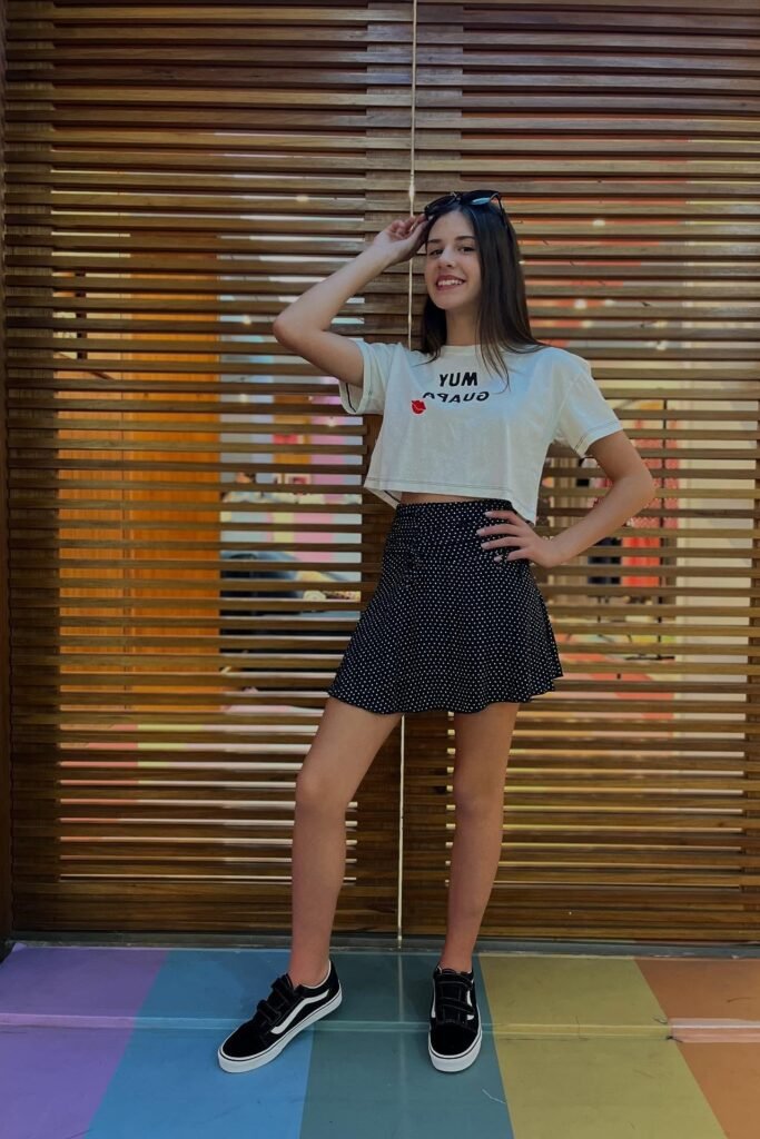 White Graphic Crop Top + Polka Dot Mini Skirt + Black Sneakers