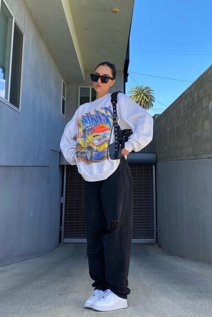 White Graphic Oversized Sweatshirt + Black Ripped Wide Leg Jeans + White Sneakers