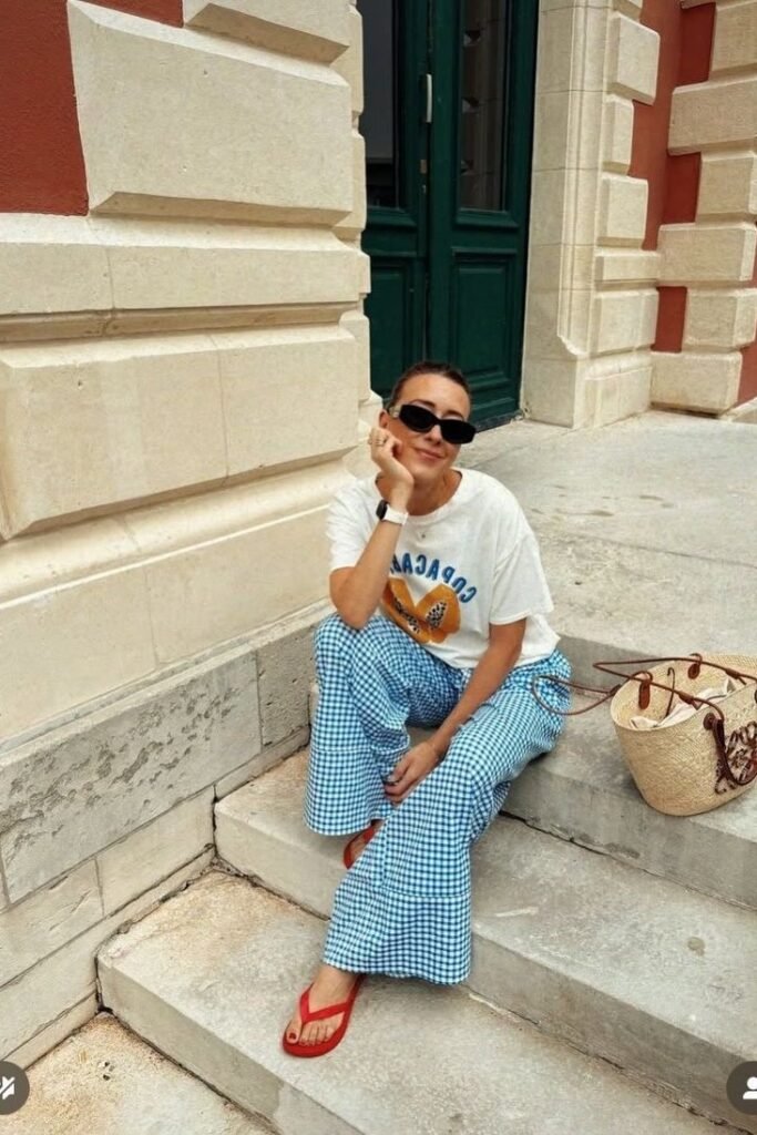 White Graphic T-Shirt + Blue Gingham Wide-Leg Trousers + Red Flip-Flops