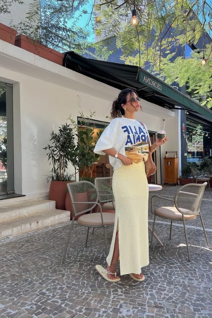 White Graphic T-Shirt + Pale Yellow Knit Maxi Skirt + Cream Flip-Flops