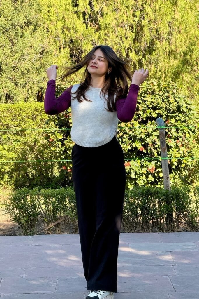 White Knit Sweater Vest + Purple Long-Sleeve Undershirt + Black Wide-Leg Trousers + White and Black Sneakers