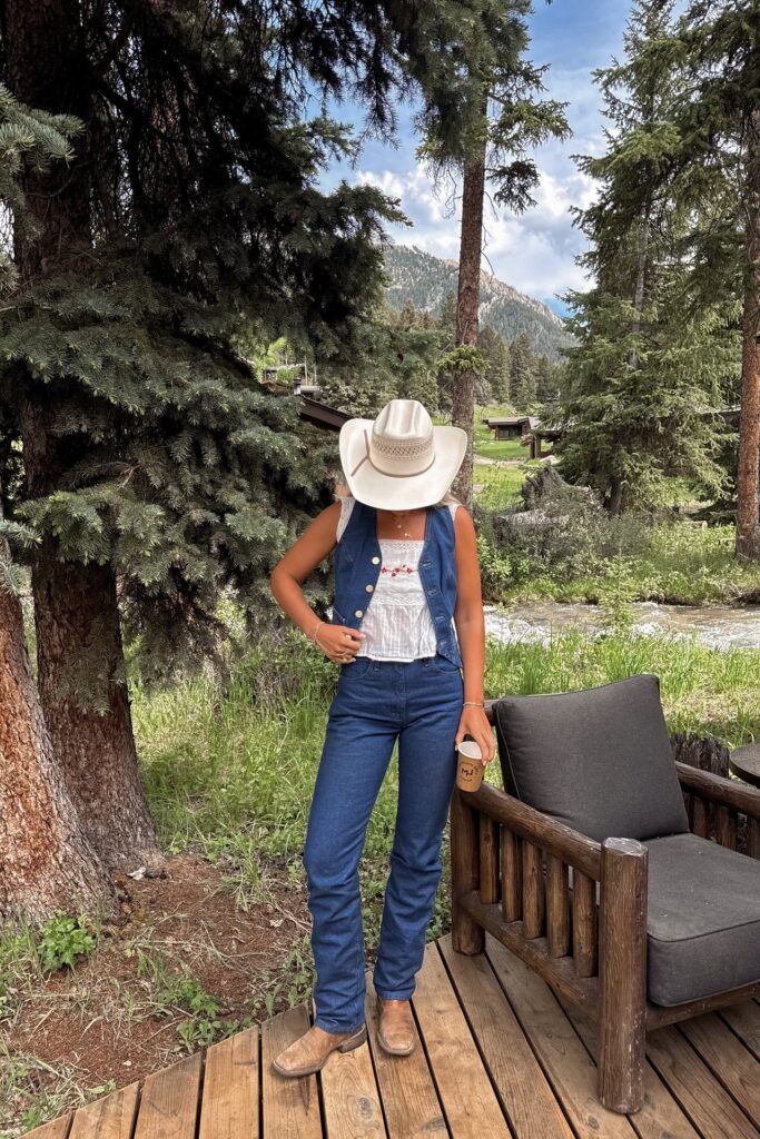 White Lace Tank & Dark Blue Denim Vest + Dark Blue Straight-Leg Jeans + Brown Leather Boots + White Cowboy Hat