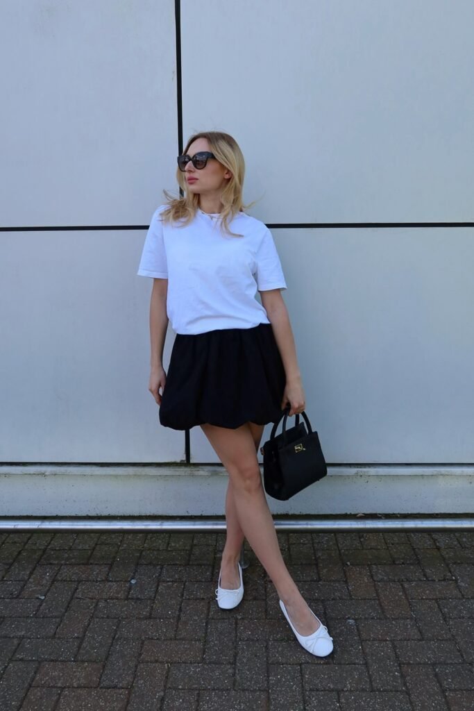 White Oversized Tee + Black Puff Mini Skirt + White Bow Ballet Flats